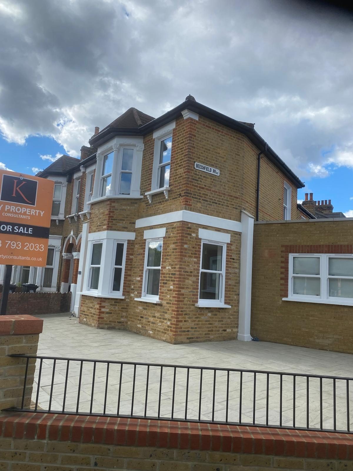 Yellow-brick corner property with repointed brickwork and chimney stack in London