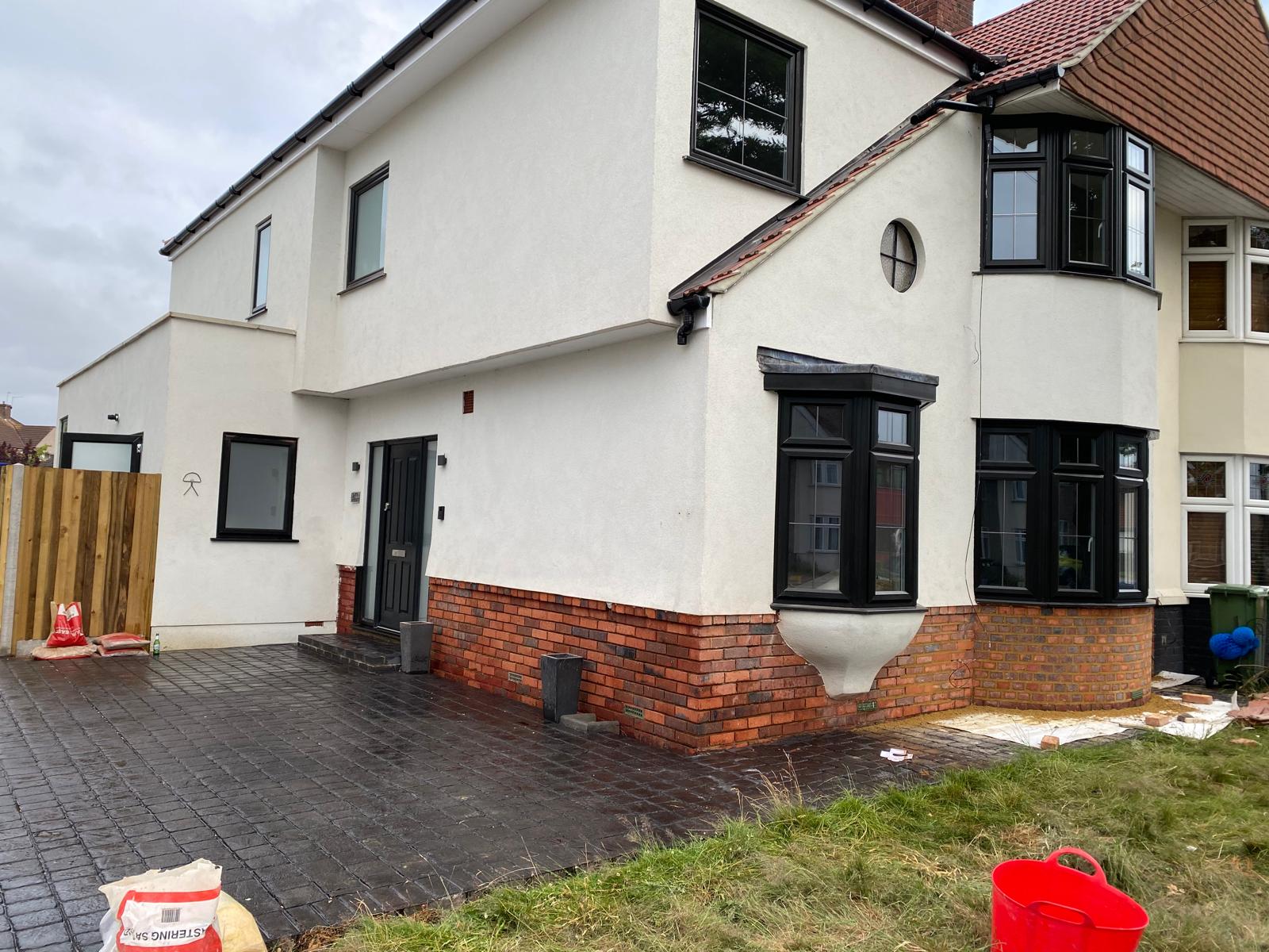 K Rend silicone render system applied to a house with brick plinth in London and Kent