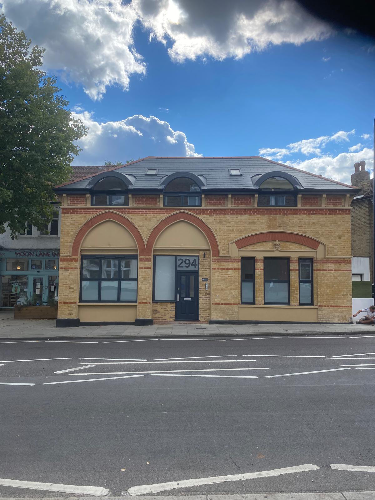 Yellow stock brick building with red brick arch detail, fully repointed in London and Kent